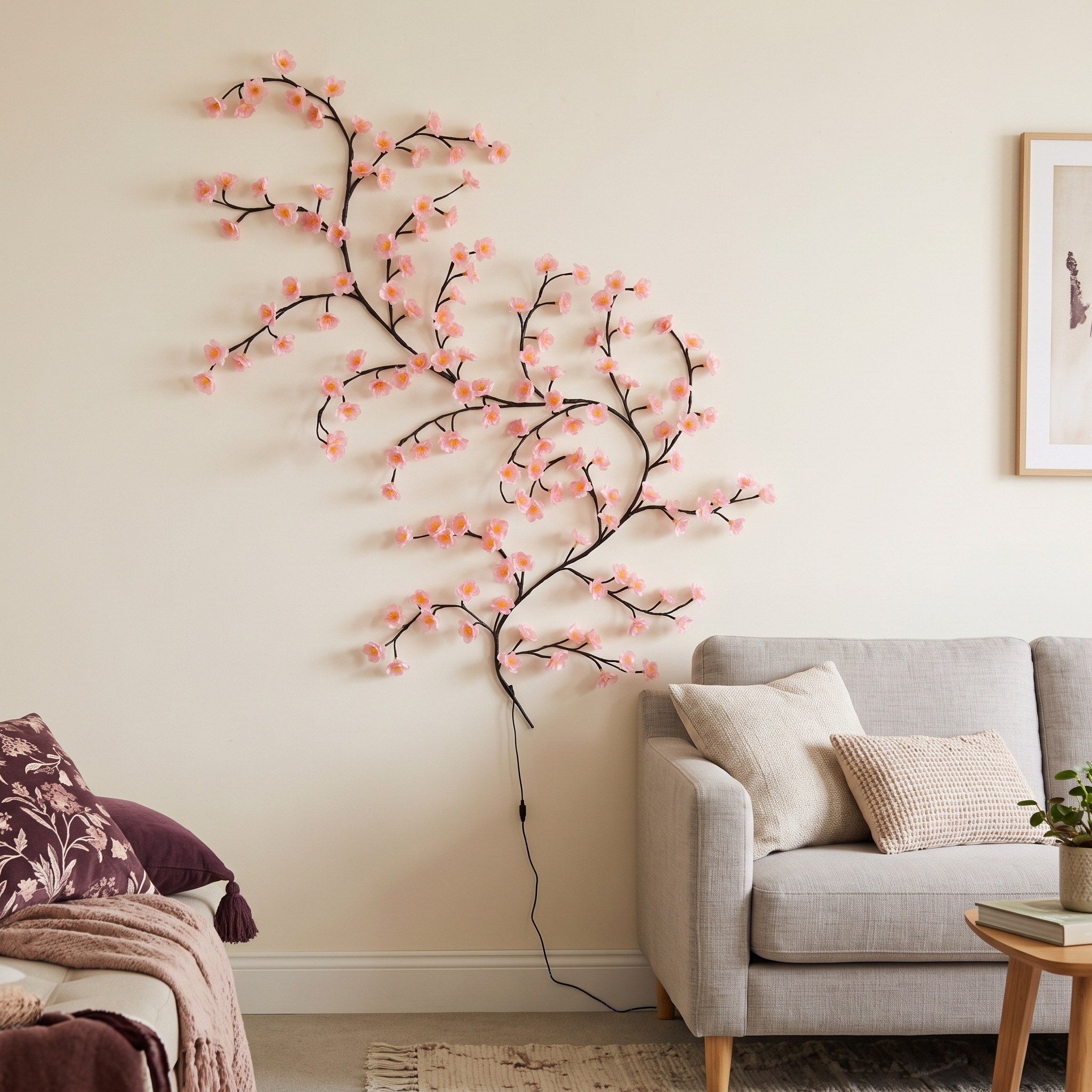 Pink blossom vine beside a sofa for room context